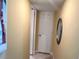 Bright hallway with neutral walls leading to multiple rooms and an appealing oval mirror at 880 Mandalay Ave # N109, Clearwater Beach, FL 33767