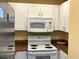 Close-up of white appliances in the kitchen, highlighting clean and modern design at 880 Mandalay Ave # N109, Clearwater Beach, FL 33767