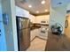 Functional kitchen featuring white cabinets and modern appliances at 880 Mandalay Ave # N109, Clearwater Beach, FL 33767