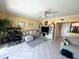 Bright living room featuring yellow walls, a workstation, comfortable seating, and a ceiling fan at 880 Mandalay Ave # N109, Clearwater Beach, FL 33767