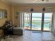 Comfortable living room with tiled floors, sofa, and stunning views of the beach from the balcony at 880 Mandalay Ave # N109, Clearwater Beach, FL 33767