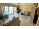 Relax in this living room with beach views, stylish decor, and easy access to the outdoors at 880 Mandalay Ave # N109, Clearwater Beach, FL 33767