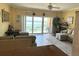 Spacious living room with tile flooring, comfortable seating, and beach views from sliding glass doors at 880 Mandalay Ave # N109, Clearwater Beach, FL 33767
