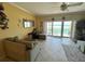 Inviting living room with access to a balcony, featuring views of the beach and surrounding area at 880 Mandalay Ave # N109, Clearwater Beach, FL 33767
