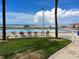 Community pool offering ocean views, lounging chairs, and landscaped green spaces at 880 Mandalay Ave # N109, Clearwater Beach, FL 33767