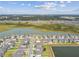 Aerial view of neighborhood featuring community lakes, green spaces, and picturesque homes at 9287 Crescent Ray Dr, Wesley Chapel, FL 33545