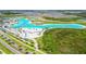 Expansive community lagoon featuring white sand beaches and recreational amenities against a backdrop of residential homes at 9287 Crescent Ray Dr, Wesley Chapel, FL 33545