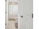 Neutral toned bathroom featuring tiled floors, a shower-tub combo, toilet, and white trim at 9287 Crescent Ray Dr, Wesley Chapel, FL 33545