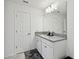 Bright bathroom with granite countertop vanity, cabinet storage, and large mirror at 9287 Crescent Ray Dr, Wesley Chapel, FL 33545