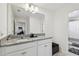 This bathroom offers granite countertops, a modern sink, decorative fixtures and tile floors at 9287 Crescent Ray Dr, Wesley Chapel, FL 33545