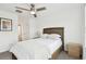 This modern bedroom has a large bed with stylish bedding, neutral walls and a glimpse into the connected bath at 9287 Crescent Ray Dr, Wesley Chapel, FL 33545