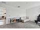 Spacious bonus room with gray carpet, neutral walls, workstation, and display of alcohol bottles at 9287 Crescent Ray Dr, Wesley Chapel, FL 33545