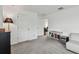 Bright bonus room features neutral walls, grey carpet and a convenient mini-bar at 9287 Crescent Ray Dr, Wesley Chapel, FL 33545