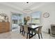 Bright dining room features a modern light fixture and sliding glass door at 9287 Crescent Ray Dr, Wesley Chapel, FL 33545