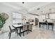 Open-concept view of dining area adjacent to kitchen with barstool seating at 9287 Crescent Ray Dr, Wesley Chapel, FL 33545