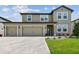 Charming two-story home featuring a three-car garage and well-manicured landscaping at 9287 Crescent Ray Dr, Wesley Chapel, FL 33545