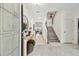 Bright foyer featuring an open stairway, console table, and decorative mirror at 9287 Crescent Ray Dr, Wesley Chapel, FL 33545
