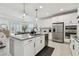 Spacious kitchen features an island, stainless steel appliances, and white cabinetry at 9287 Crescent Ray Dr, Wesley Chapel, FL 33545