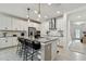Open concept kitchen featuring granite countertops, stainless steel appliances, and modern bar stools at 9287 Crescent Ray Dr, Wesley Chapel, FL 33545