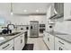 Elegant kitchen with stainless steel appliances, granite countertops, and subway tile backsplash at 9287 Crescent Ray Dr, Wesley Chapel, FL 33545