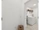 Bright laundry room with a modern washer and dryer, shelving, and tile flooring at 9287 Crescent Ray Dr, Wesley Chapel, FL 33545