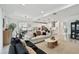 Bright, open-concept living room and kitchen with modern decor and lots of natural light at 9287 Crescent Ray Dr, Wesley Chapel, FL 33545