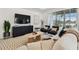 Comfortable living room area featuring neutral tones, plush seating, and view to patio at 9287 Crescent Ray Dr, Wesley Chapel, FL 33545