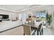 Open-concept living, dining area with view to outdoor patio and serene pond at 9287 Crescent Ray Dr, Wesley Chapel, FL 33545