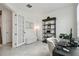 Bright office space with French doors, tiled floors, and an elegant bookshelf and furniture at 9287 Crescent Ray Dr, Wesley Chapel, FL 33545