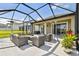 Covered patio with an outdoor seating area and heaters for year-round comfort at 9287 Crescent Ray Dr, Wesley Chapel, FL 33545