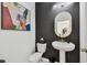 Stylish powder room featuring a pedestal sink, modern fixtures, and elegant decor at 9287 Crescent Ray Dr, Wesley Chapel, FL 33545