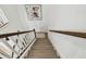 Stairway with wood steps, white railings and a decorative rug below at 9287 Crescent Ray Dr, Wesley Chapel, FL 33545