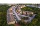 An aerial view of a well-maintained apartment complex featuring mature trees, ponds and organized parking areas at 9516 Newdale Way # 101, Riverview, FL 33578