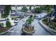 Aerial view of a gated community entrance and parking, surrounded by lush landscaping and mature trees at 9516 Newdale Way # 101, Riverview, FL 33578