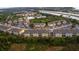 An aerial view of an apartment complex situated amongst mature trees, ponds and an adjacent highway at 9516 Newdale Way # 101, Riverview, FL 33578