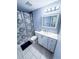 Well-lit bathroom featuring tile floors, a vanity with sink, and a shower with circular patterned curtain at 9516 Newdale Way # 101, Riverview, FL 33578