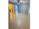 Spacious bedroom featuring tile flooring, ceiling fan, and a view to the bathroom for added convenience at 9516 Newdale Way # 101, Riverview, FL 33578