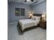 Cozy bedroom featuring neutral decor, tiled floors, natural light, and a comfortable bed setup at 9516 Newdale Way # 101, Riverview, FL 33578