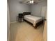 Bedroom featuring neutral decor, tiled floors, and natural light, ideal for a comfortable living space at 9516 Newdale Way # 101, Riverview, FL 33578