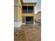 Exterior view of a building with a screen enclosed porch, featuring lattice detailing and neutral color scheme at 9516 Newdale Way # 101, Riverview, FL 33578