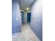 Hallway with neutral tiled floor, easy access to rooms, and convenient electrical panel access at 9516 Newdale Way # 101, Riverview, FL 33578