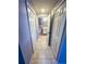 Bright hallway with tiled floor, closet space, and access to the bathroom providing ample storage at 9516 Newdale Way # 101, Riverview, FL 33578