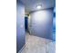 Hallway with neutral tiled floor, leading to other rooms, and convenient electrical panel access at 9516 Newdale Way # 101, Riverview, FL 33578