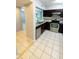 Well-lit kitchen featuring stainless steel appliances, tile backsplash, and dark wood cabinetry at 9516 Newdale Way # 101, Riverview, FL 33578