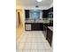 Modern kitchen features stainless steel appliances, dark wood cabinets, and granite countertops at 9516 Newdale Way # 101, Riverview, FL 33578