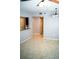 Bright living area featuring tile floors, an open layout, and a partial view of the modern kitchen at 9516 Newdale Way # 101, Riverview, FL 33578