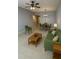 Comfortable living space with stylish furniture, tile flooring, and a view of the dining area and kitchen at 9516 Newdale Way # 101, Riverview, FL 33578
