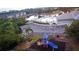 Aerial view of a colorful playground with water feature, set near a community pool and picturesque lake at 9516 Newdale Way # 101, Riverview, FL 33578