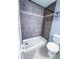 Bathroom showing shower with dark grey tiled backsplash at 9516 Newdale Way # 101, Riverview, FL 33578