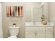 Contemporary bathroom with a white vanity, brushed nickel fixtures, and neutral decor at 9657 Runaway Breeze Dr, Land O Lakes, FL 34637